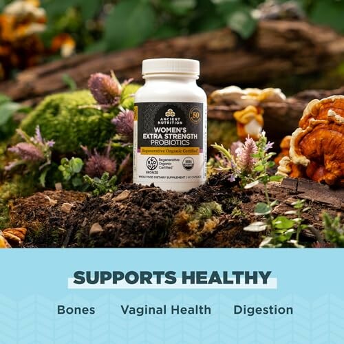 Bottle of women's extra strength probiotics on a forest floor.